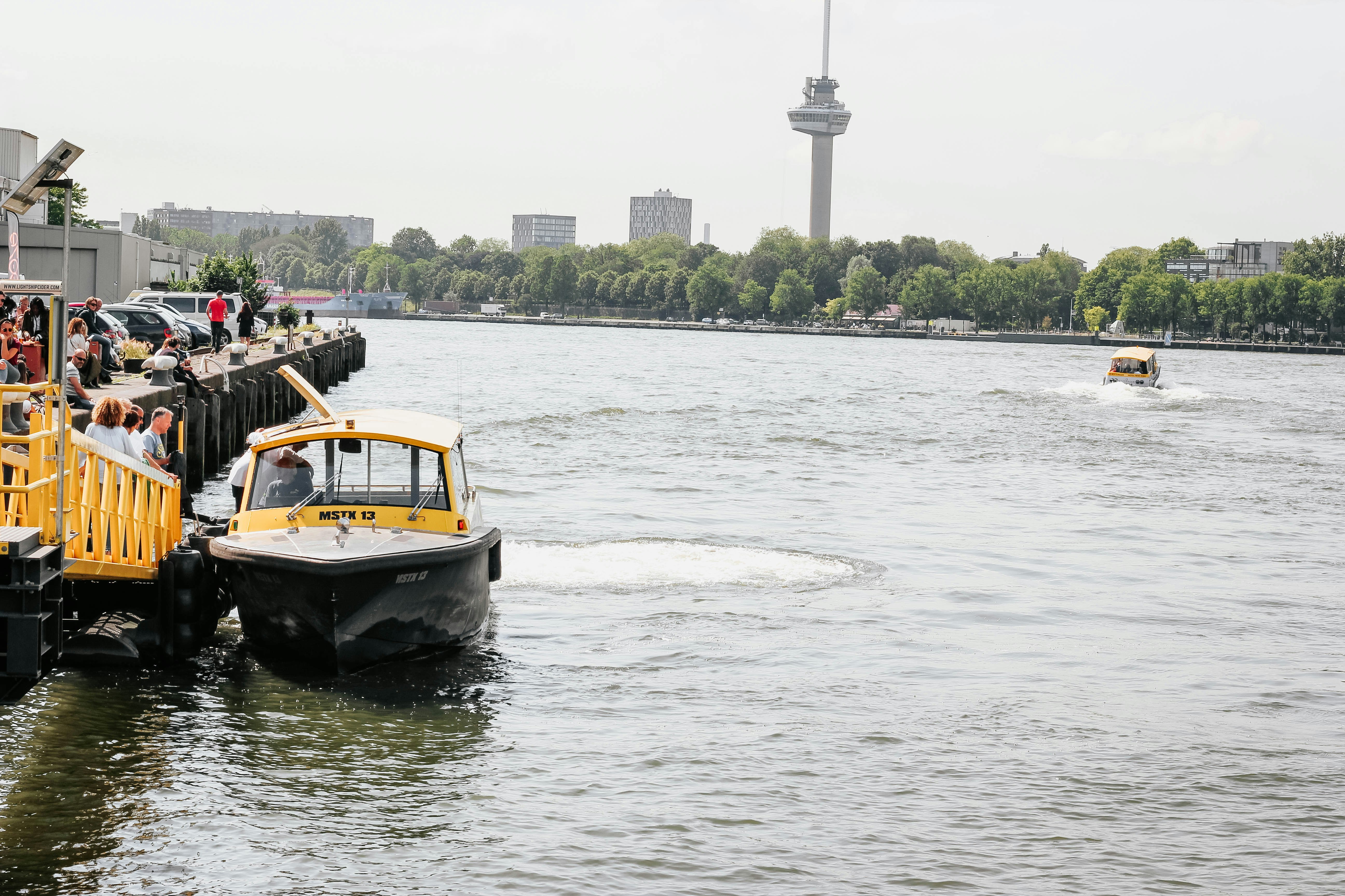 white, black, and yellow boat on body of water